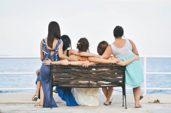 a group of women playing a piano