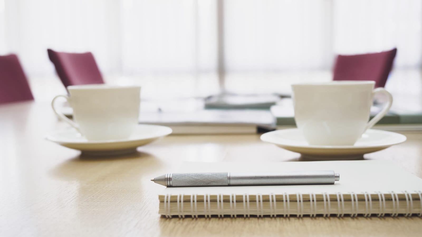 a set of white plates and a knife on a table