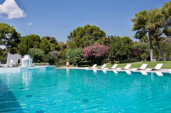 a pool with chairs around it