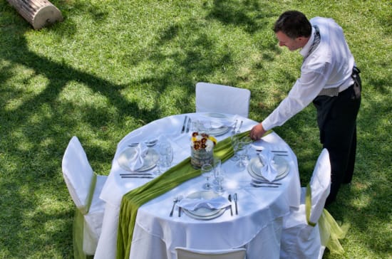 a man standing next to a table with food on it
