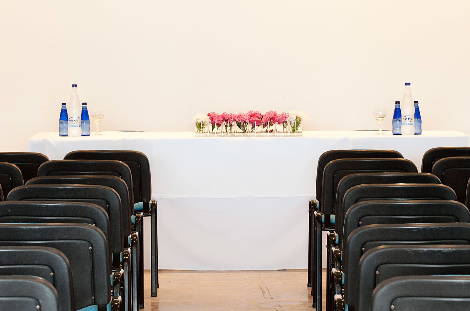 a row of chairs with bottles on top of them
