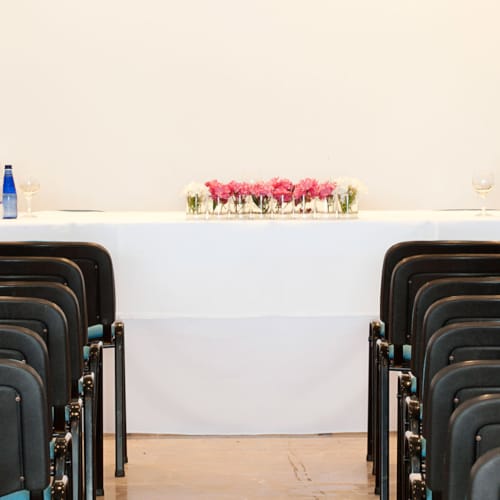 a row of chairs with bottles on top of them