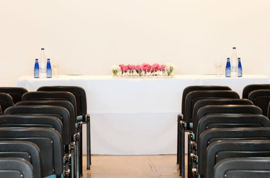 a row of chairs with bottles on top of them