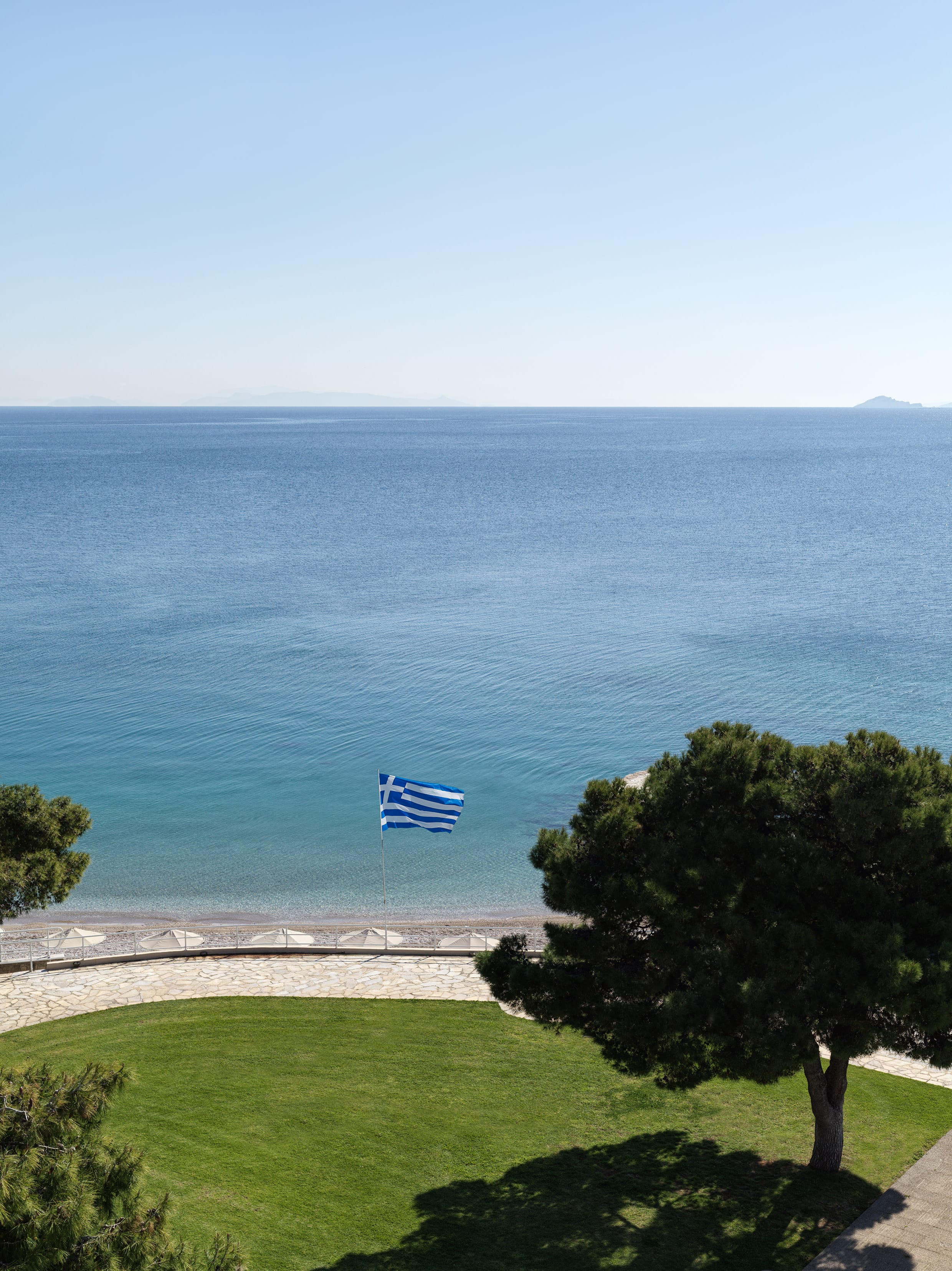 a flag flying over a grassy area