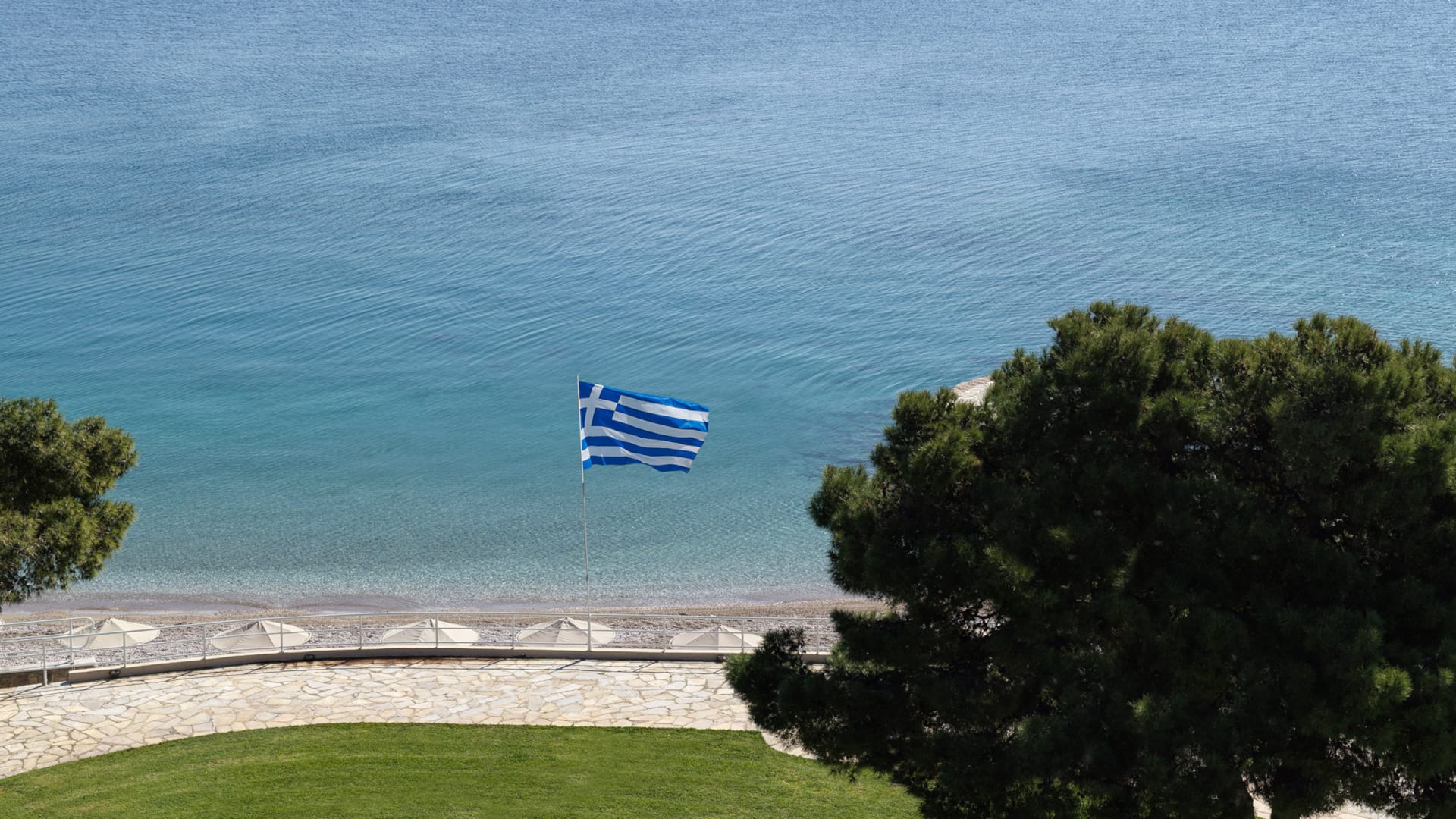 a flag flying over a grassy area