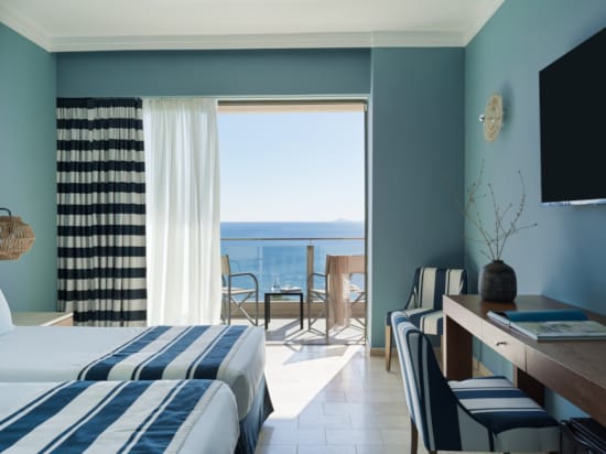 a room with a bed desk and a window