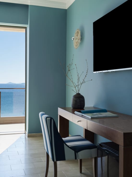 a desk with a chair and a plant on it