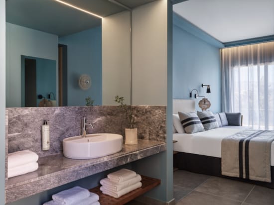 a bathroom with a sink and a bed