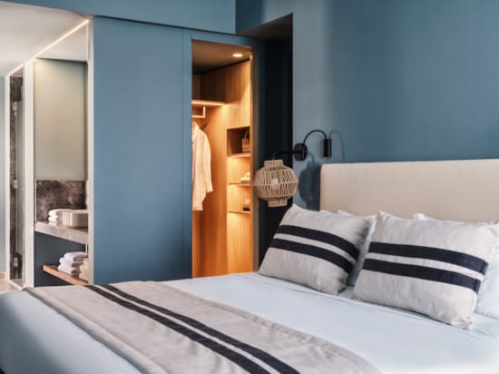 a bed with a white and black striped pillow