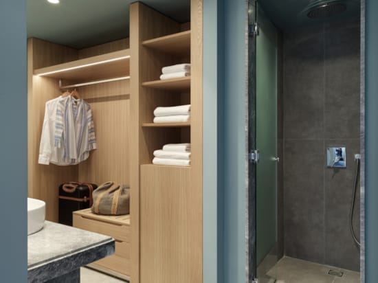 a bathroom with a shelf and towels