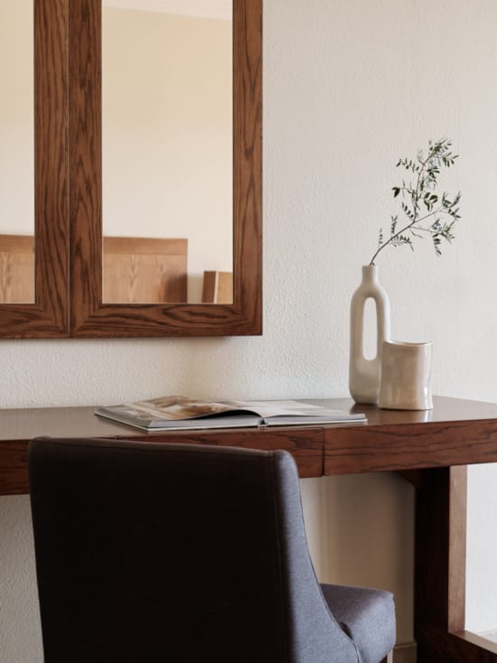 a desk with a vase and a plant on it