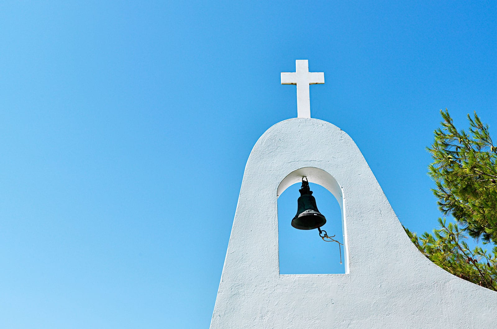a bell on a white building