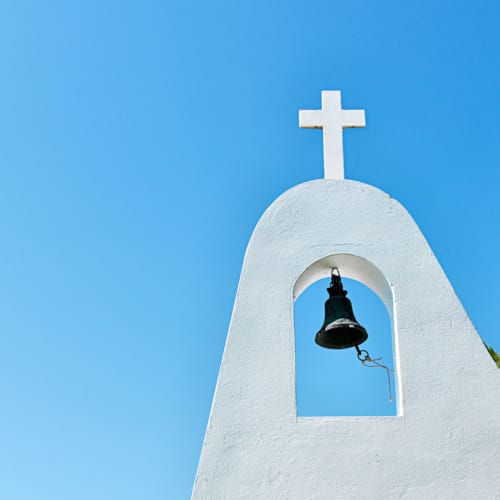 a bell on a white building