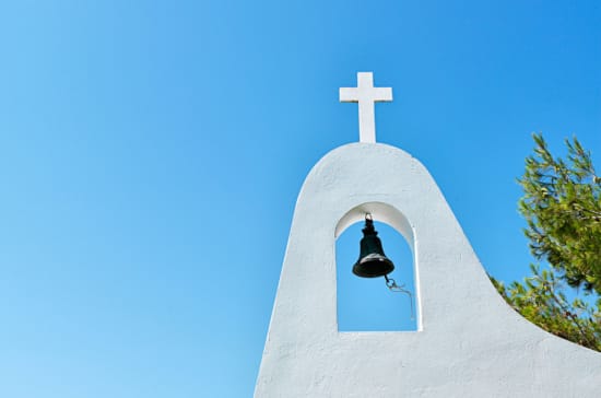 a bell on a white building