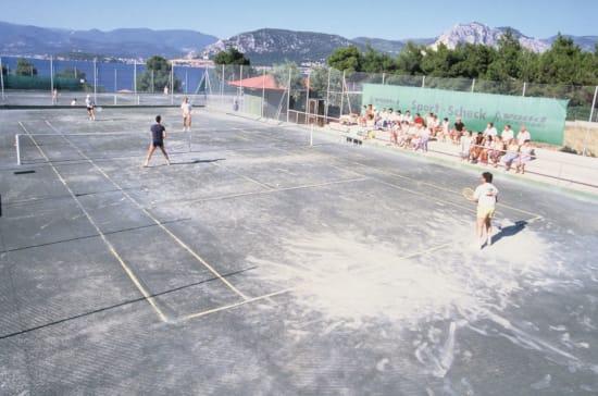 people playing tennis on a court