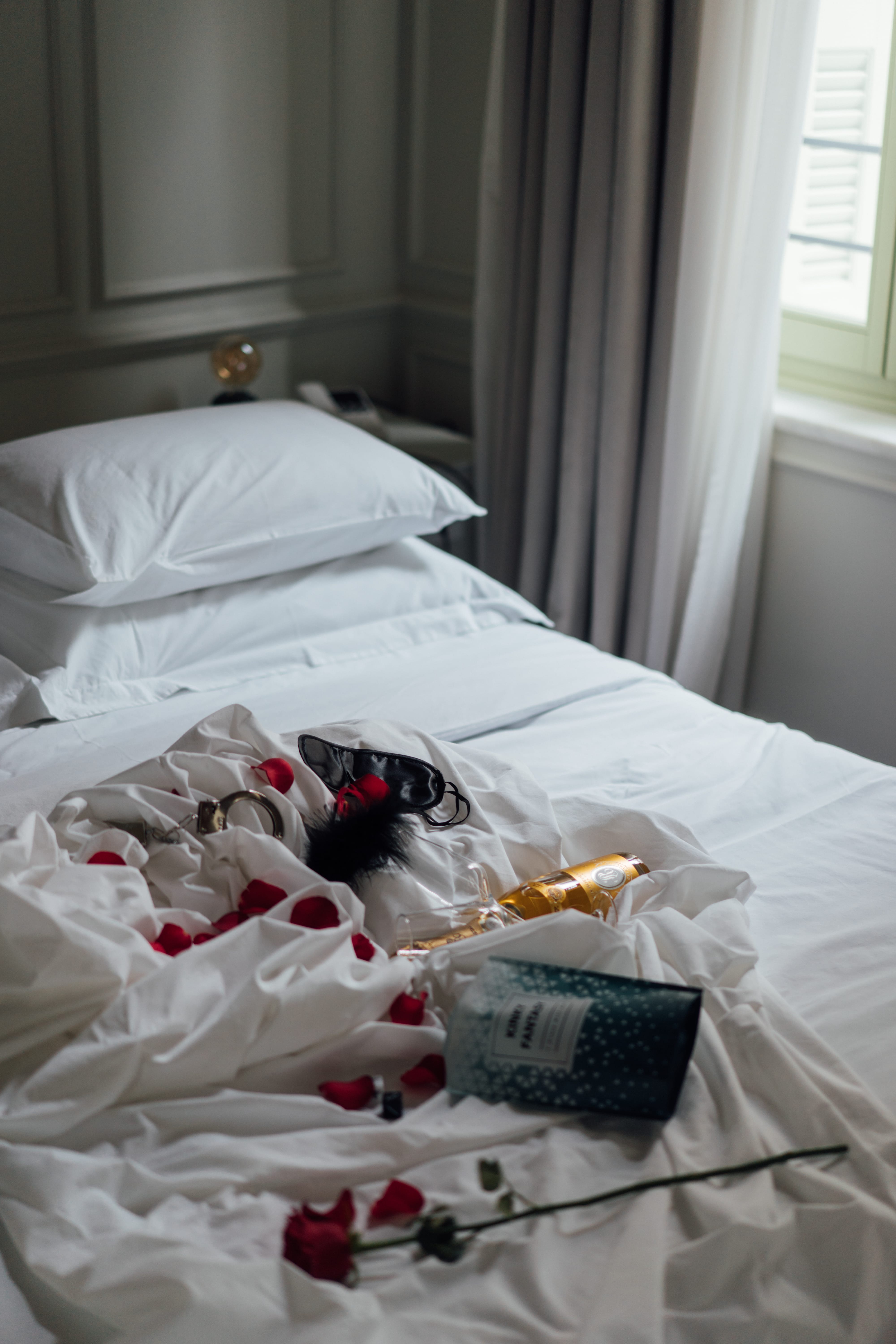 a bed with a white sheet and a white pillow