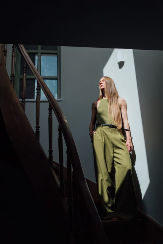 a person in a dress standing on a staircase