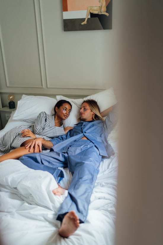 a man and woman lying in a bed