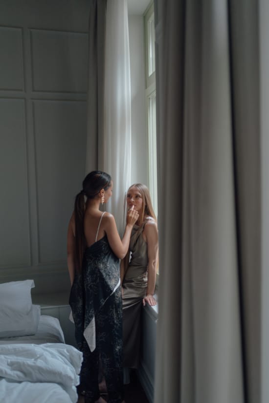 a woman standing next to another woman