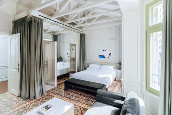 a bedroom with a bed and a couch