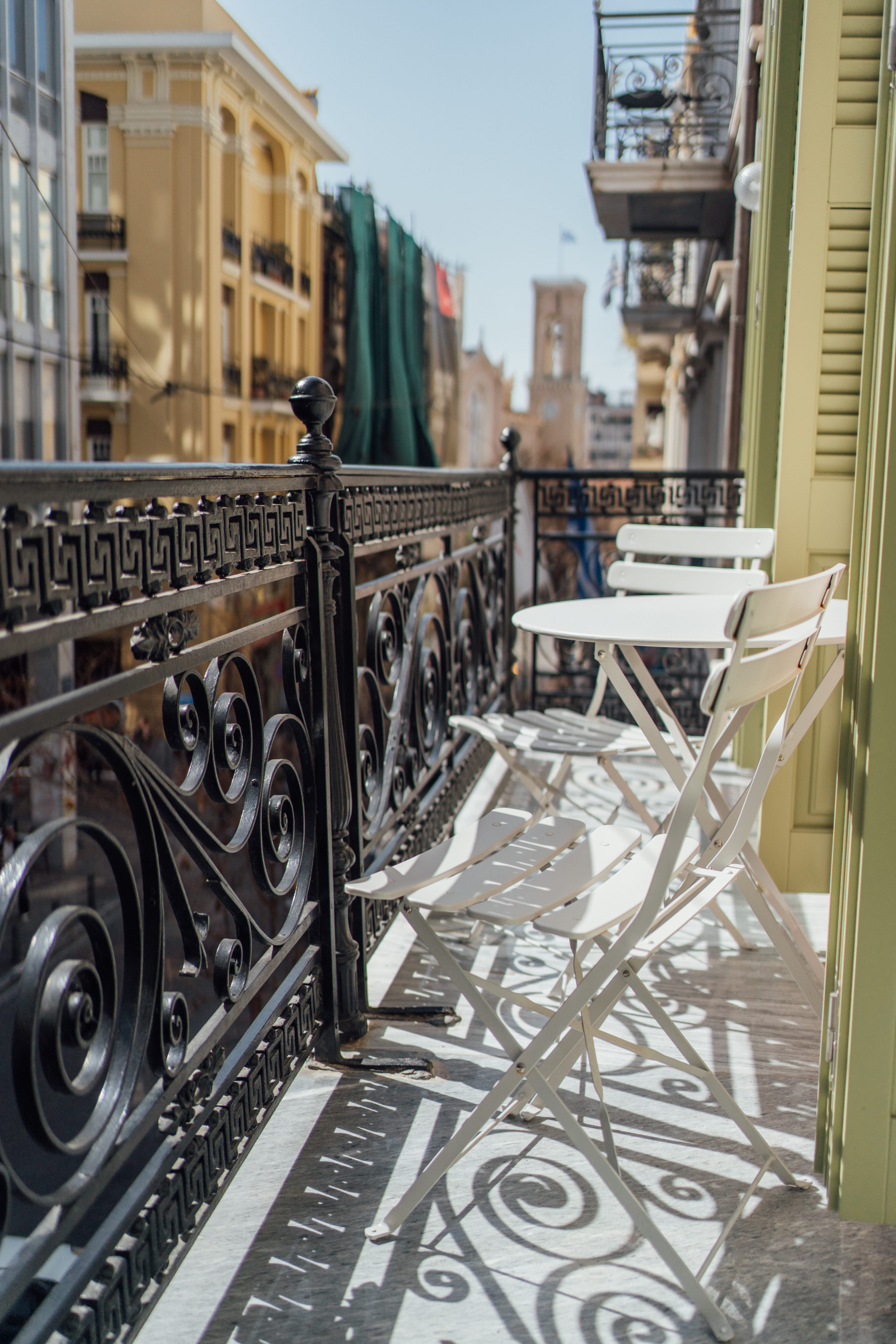 a table and chairs on a balcony