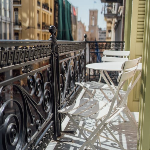 a table and chairs on a balcony