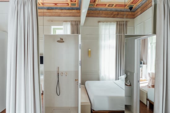 a bathroom with a shower unit and toilet