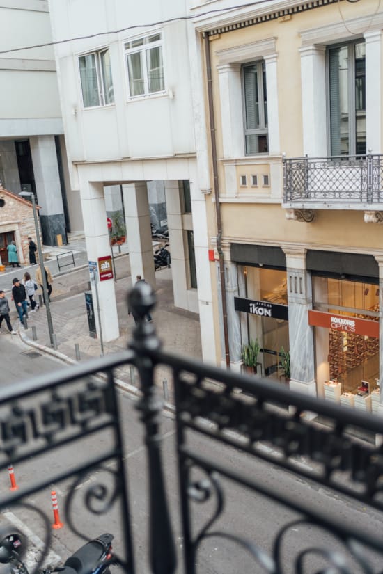 a street with a railing and buildings