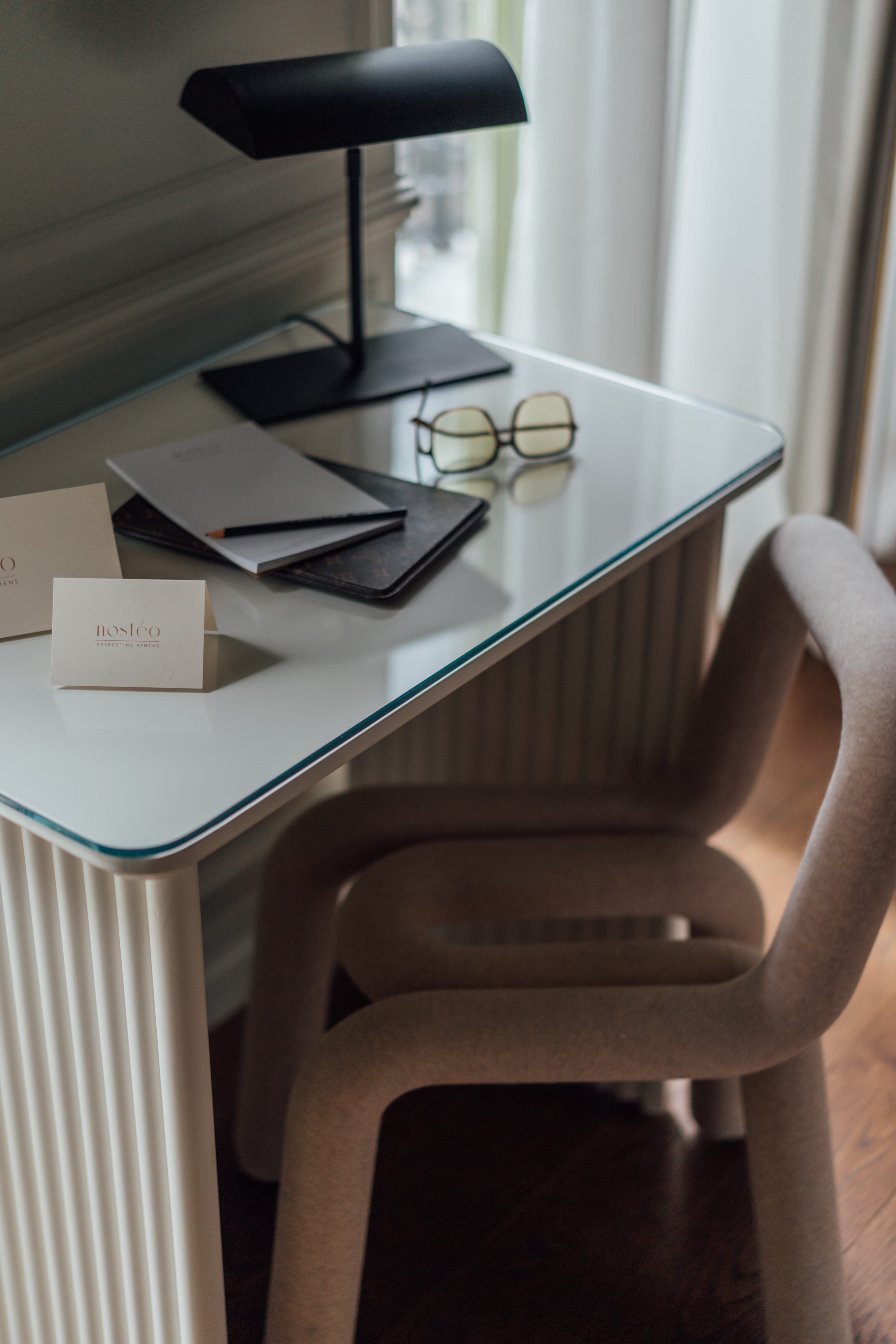 a desk with a chair and a lamp