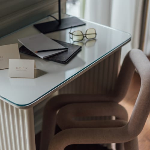 a desk with a chair and a lamp