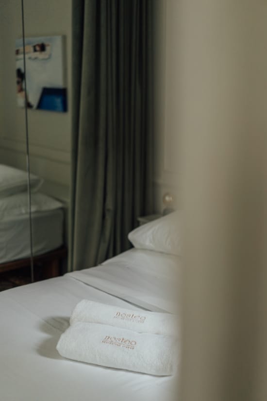 a bed with a white sheet and a white pillow