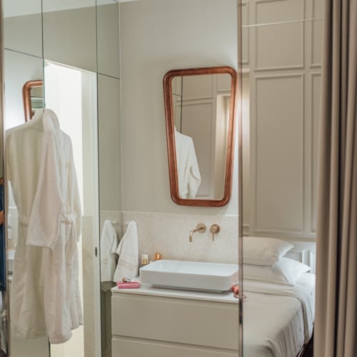 a bathroom with a mirror and a sink