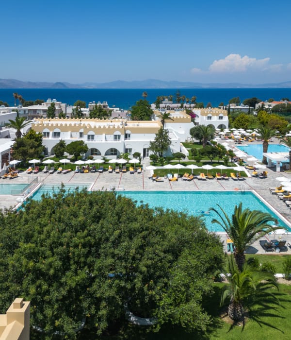 a pool surrounded by trees and buildings