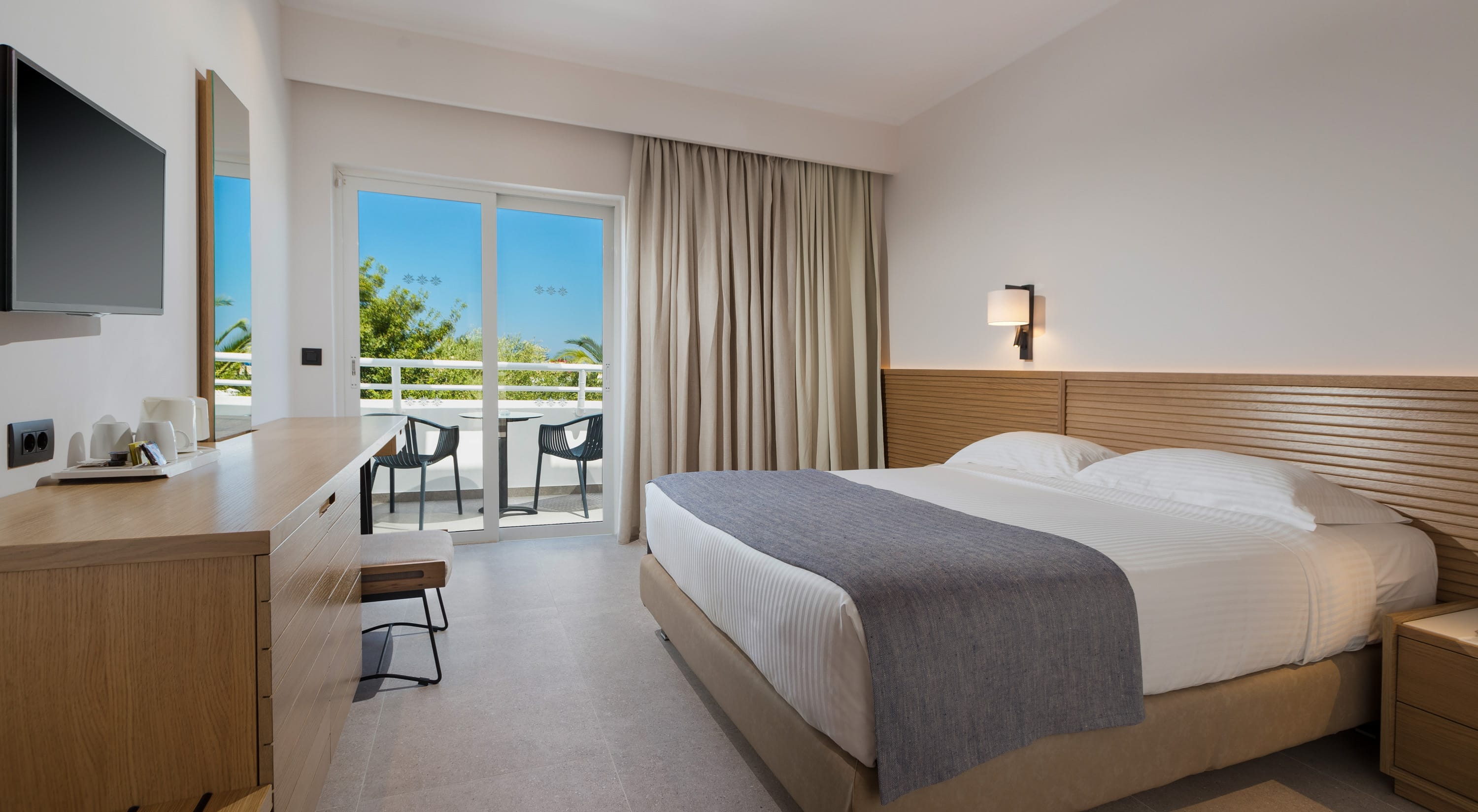 a hotel room with a bed and a desk