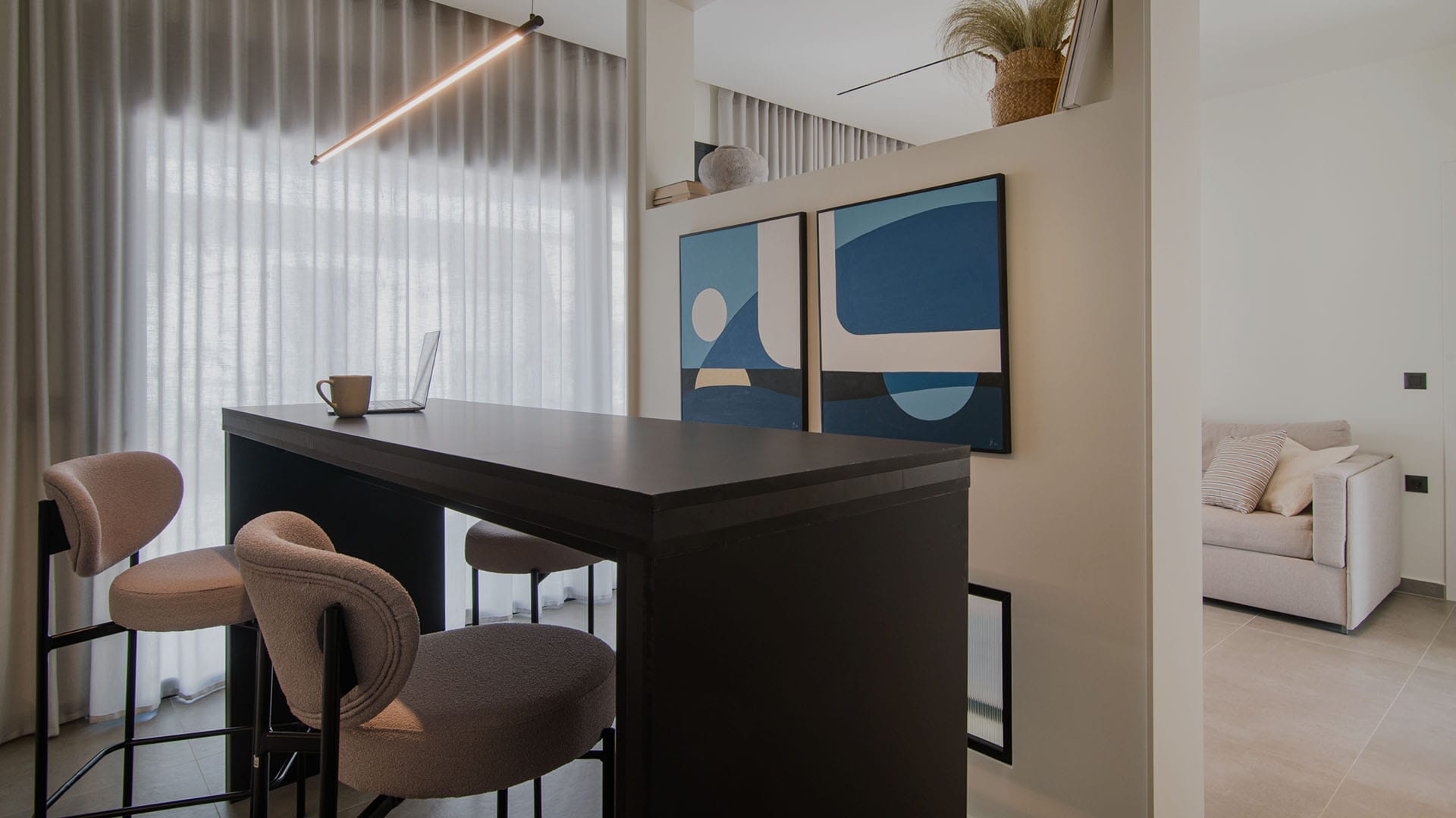 a room with a desk and chairs