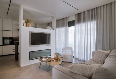 a living room with a tv and couches