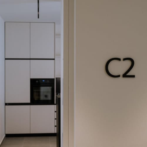 a white wall with a black television