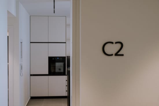 a white wall with a black television