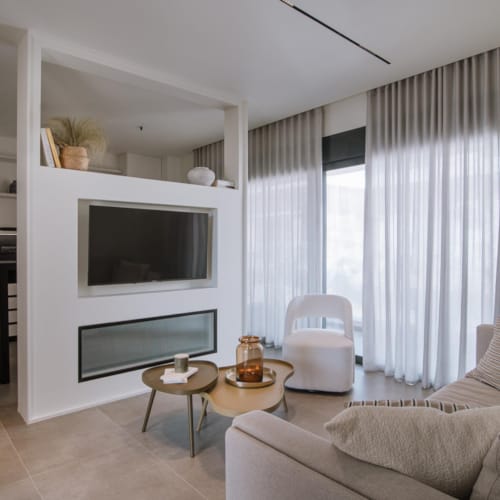 a living room with a tv and couches