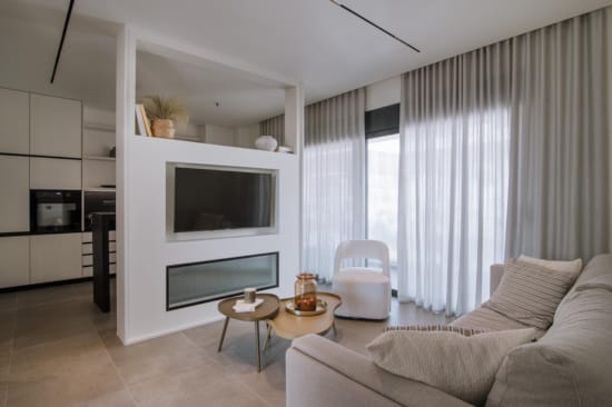 a living room with a tv and couches