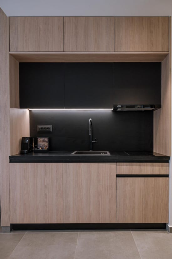 a kitchen with a black countertop