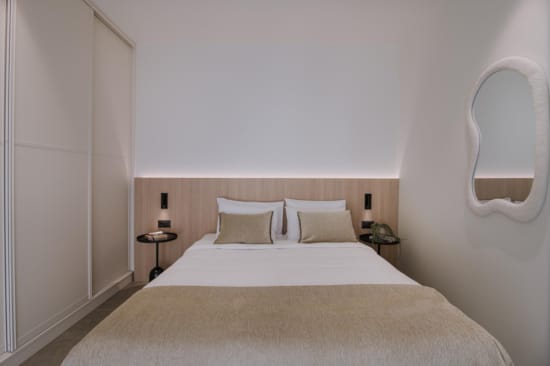 a bed with a lamp on the side