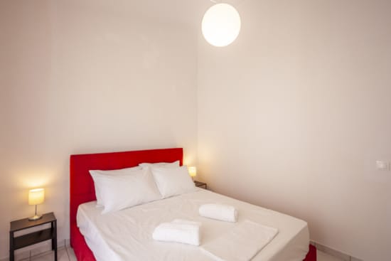 a bed with a red headboard