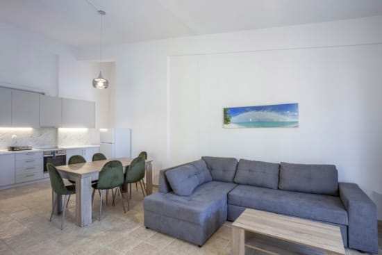 a room with a couch and chairs