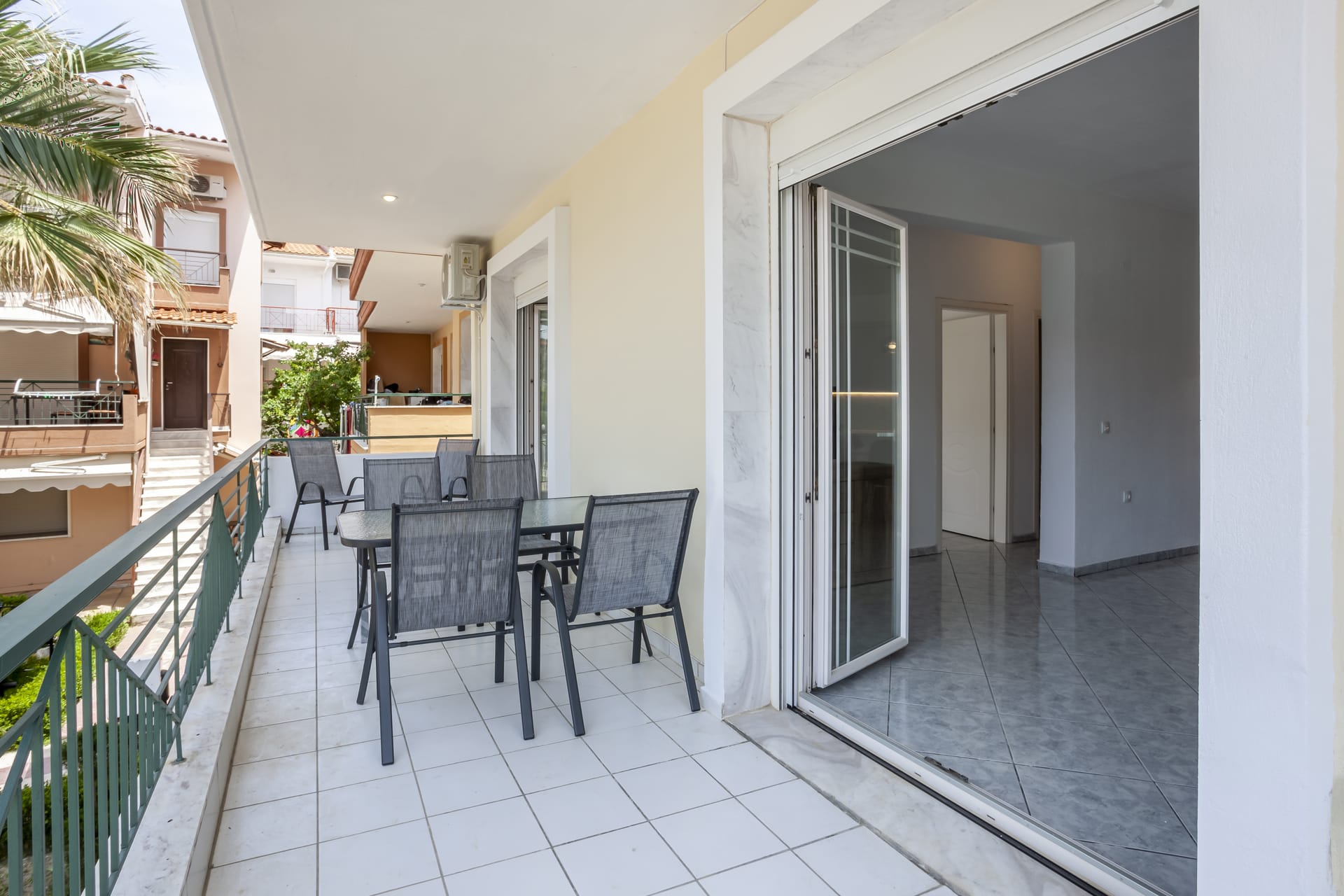 a room with a table chairs and a railing