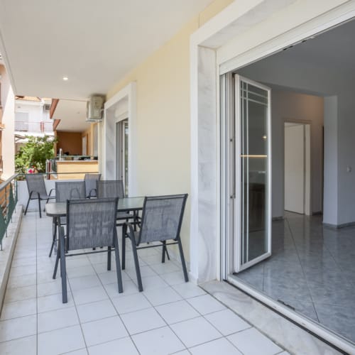 a room with a table chairs and a railing
