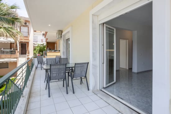 a room with a table chairs and a railing