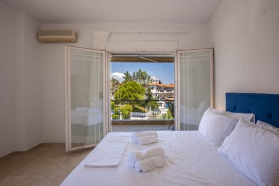 a bed with white sheets and pillows