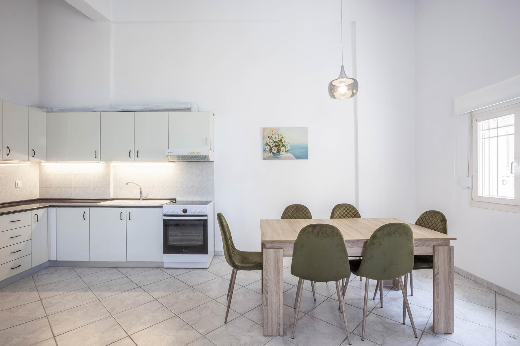 a kitchen with a table and chairs