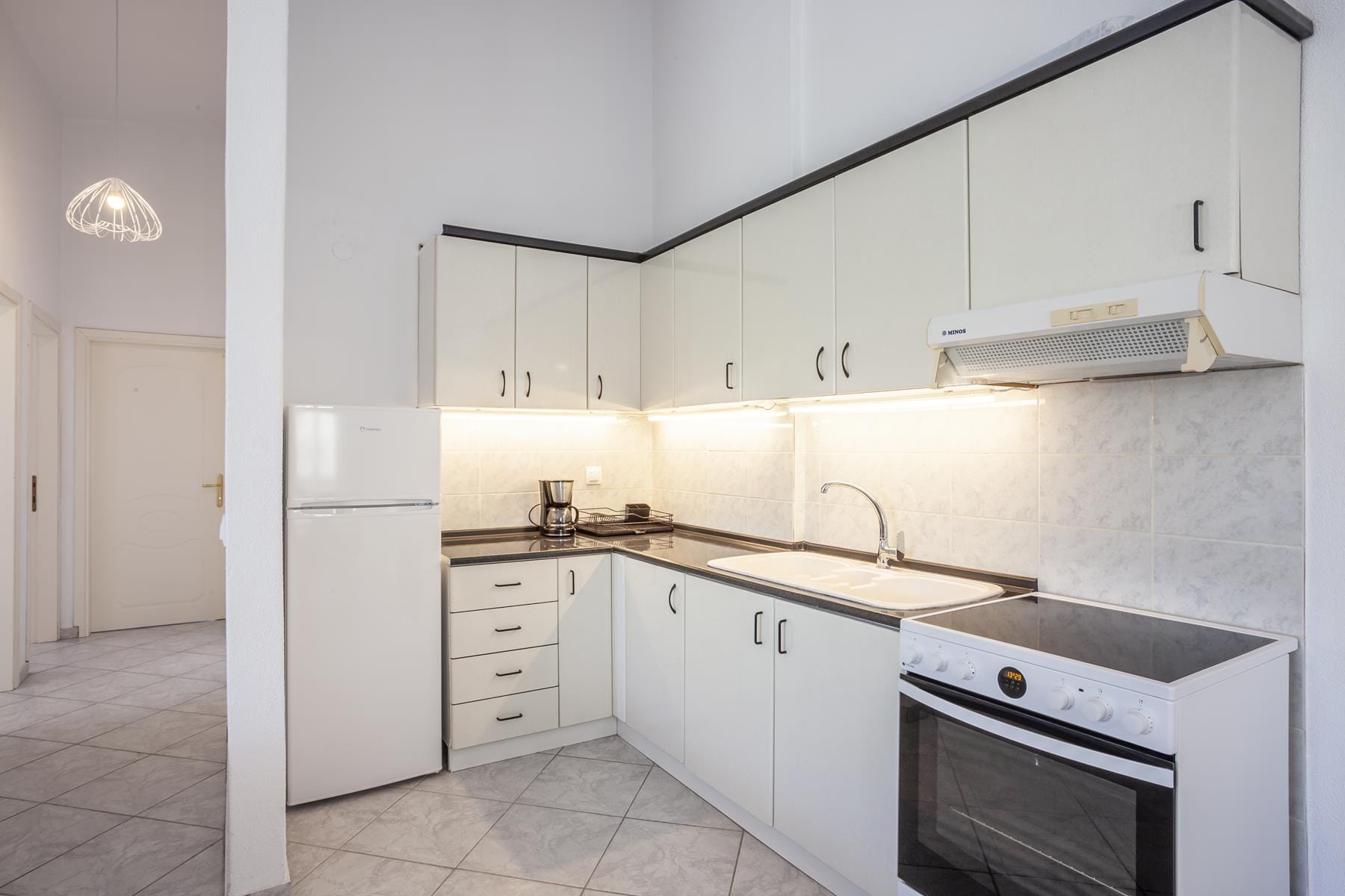 a kitchen with white cabinets